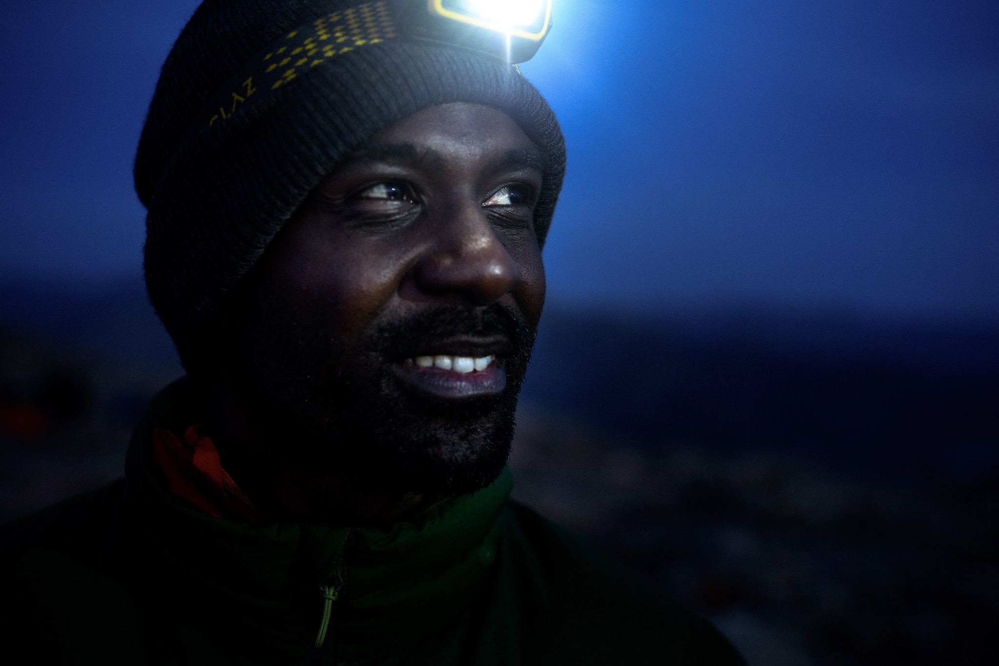 Alexandre, bonnet et lampe frontale allumée, dans la pénombre